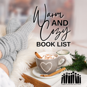 Someone reclines on fuzzy blanket with oversized socks, next to a mug with a heart on it, filled with hot chocolate, with a cinnamon stick inside and on the saucer, with other decorative elements, and the text "Warm and Cozy Book List."